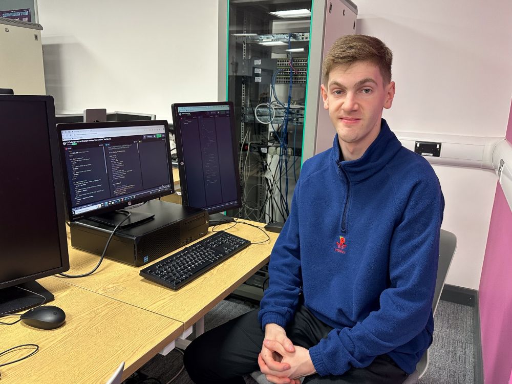 Student Nathan Quee sits at a desk in a computer suite at SERC Bangor Campus